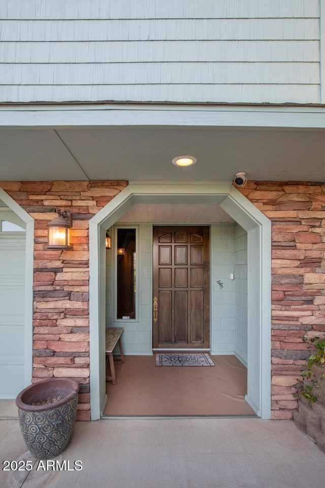 doorway to property featuring stone siding