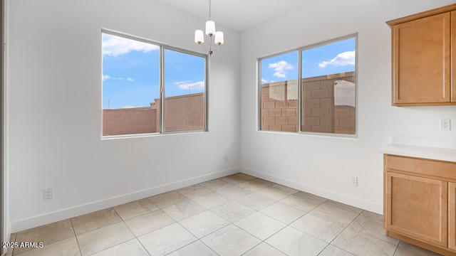 17841 W Windsor Blvd, Litchfield Park, AZ 85340 - unfurnished dining area featuring baseboards and a chandelier