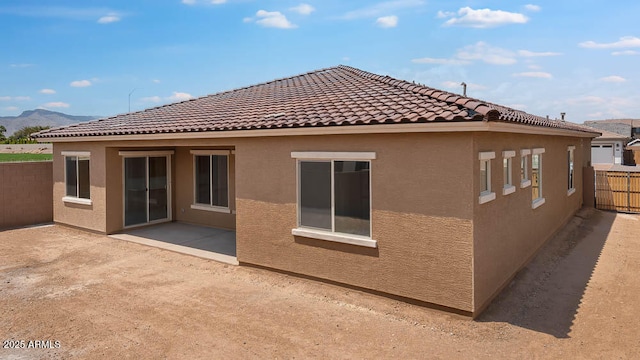 17841 W Windsor Blvd, Litchfield Park, AZ 85340 - rear view of house featuring stucco siding, fence, a patio, and a mountain view