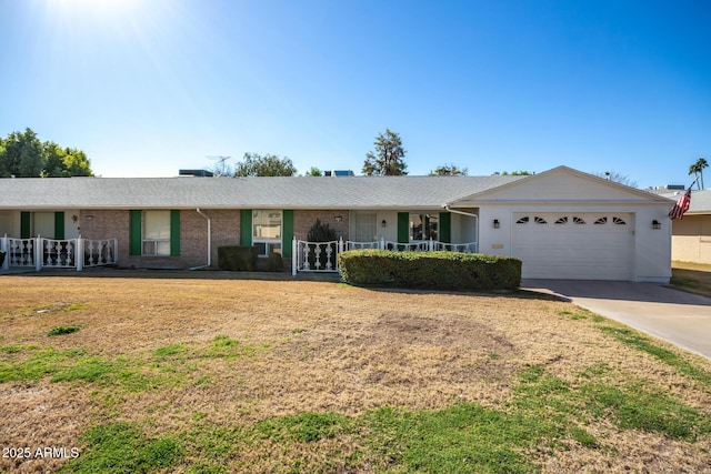 single story home featuring a garage, a front lawn, and covered porch