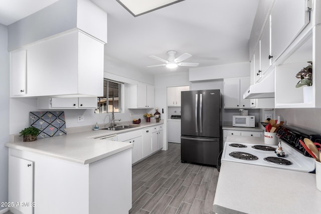 kitchen featuring sink, white cabinets, ceiling fan, kitchen peninsula, and white appliances