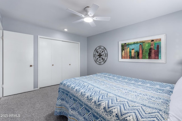 carpeted bedroom featuring ceiling fan and a closet