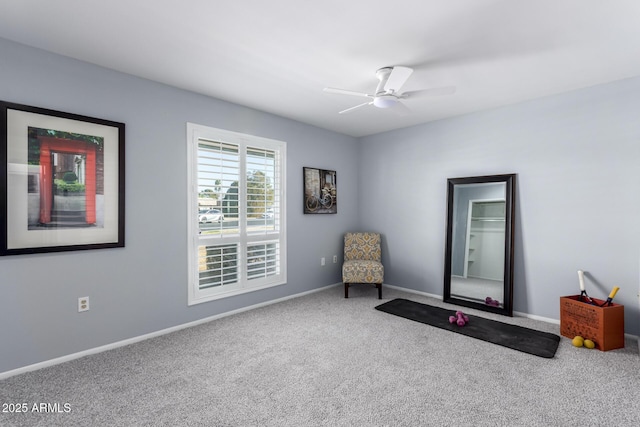 sitting room featuring ceiling fan and carpet