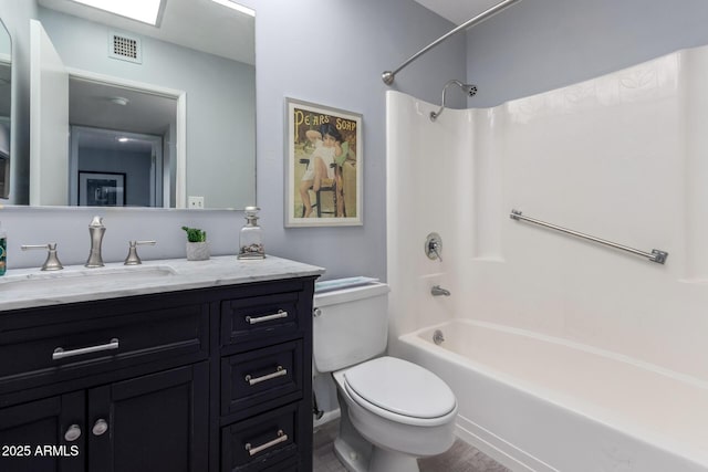 full bathroom featuring vanity, tub / shower combination, and toilet