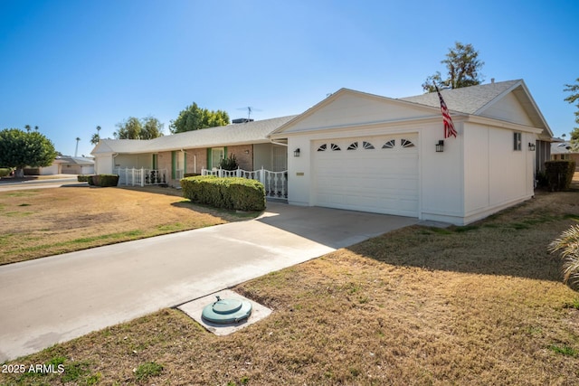 ranch-style house with a garage, a front lawn, and covered porch