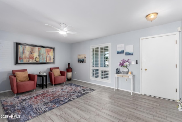 foyer entrance featuring ceiling fan and light wood-type flooring