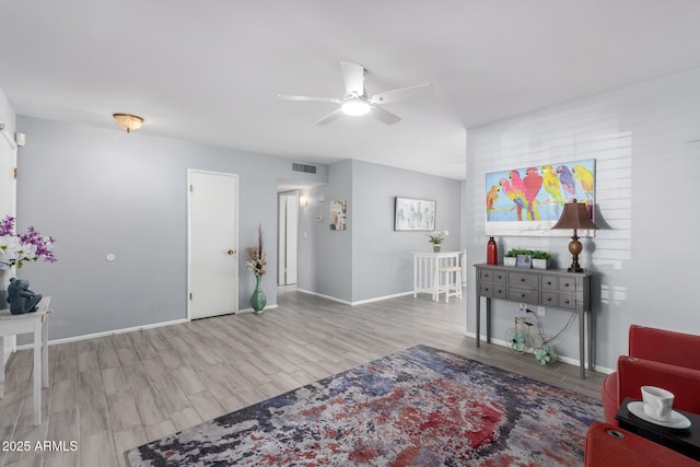 sitting room with ceiling fan and light hardwood / wood-style flooring