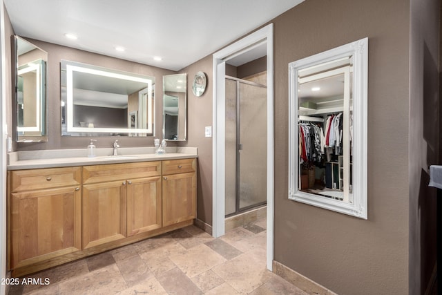 bathroom featuring vanity and a shower with shower door