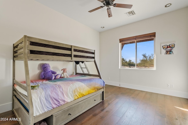 bedroom with baseboards, visible vents, and dark wood finished floors