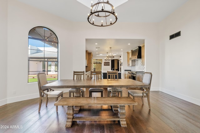 dining space featuring baseboards, visible vents, wood finished floors, a chandelier, and recessed lighting