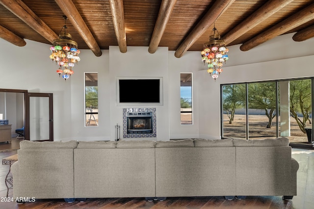 living area featuring an inviting chandelier, wood ceiling, and a tiled fireplace