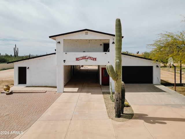 view of front of house featuring a garage and stucco siding