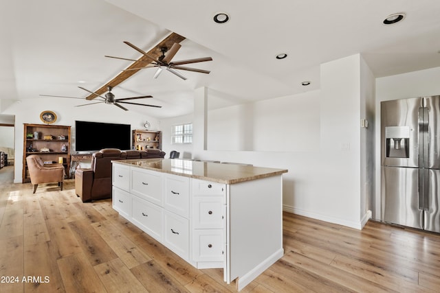 kitchen with stainless steel refrigerator with ice dispenser, a center island, light wood-style flooring, and white cabinets