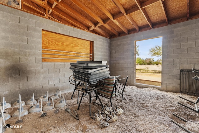 misc room with concrete block wall