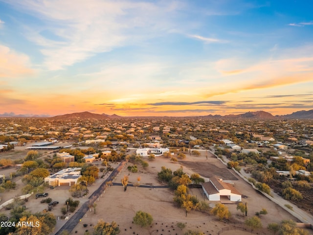 aerial view at dusk featuring a mountain view