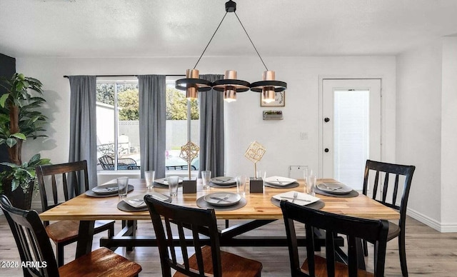 3330 E Cypress St, Phoenix, AZ 85008 - dining area featuring light wood-style floors, baseboards, and a chandelier