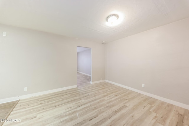 3238 W Rose Ln, Phoenix, AZ 85017 - empty room with light wood-style flooring and baseboards