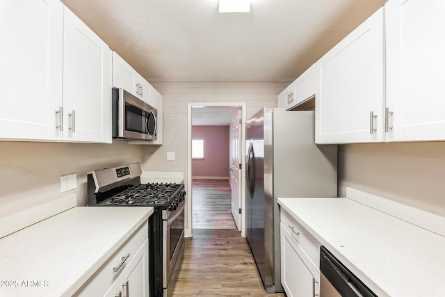 3238 W Rose Ln, Phoenix, AZ 85017 - kitchen featuring appliances with stainless steel finishes, light wood finished floors, light countertops, and white cabinets