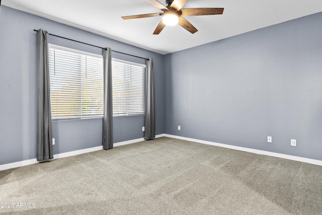 empty room with ceiling fan and carpet