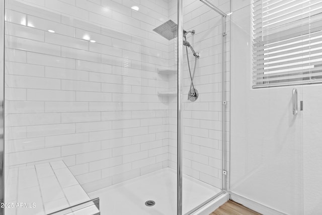 bathroom featuring a shower with shower door