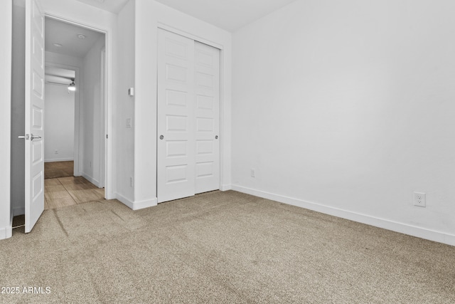 unfurnished bedroom featuring a closet and carpet