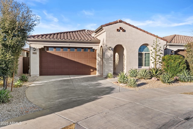 mediterranean / spanish-style home with a garage