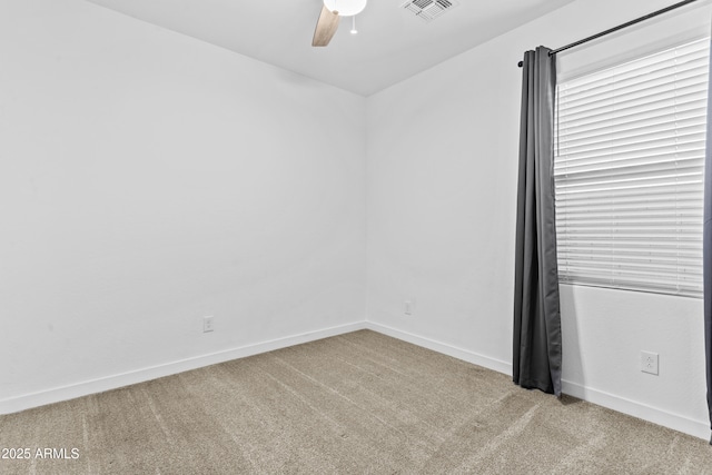 spare room with ceiling fan and light colored carpet