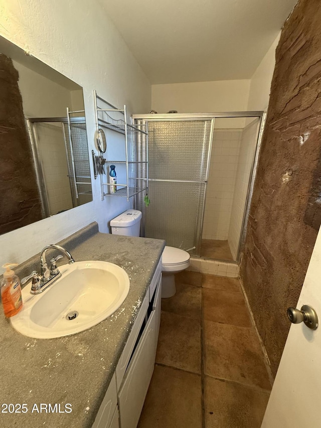 bathroom featuring an enclosed shower, vanity, tile patterned floors, and toilet