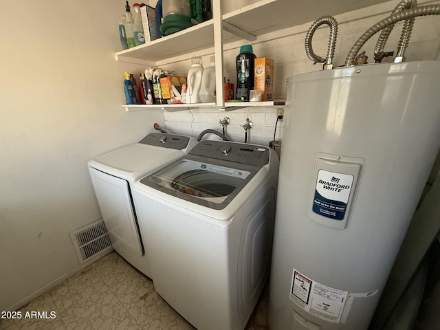 laundry area with water heater and washer and dryer