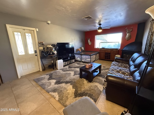 living room with ceiling fan and light tile patterned floors