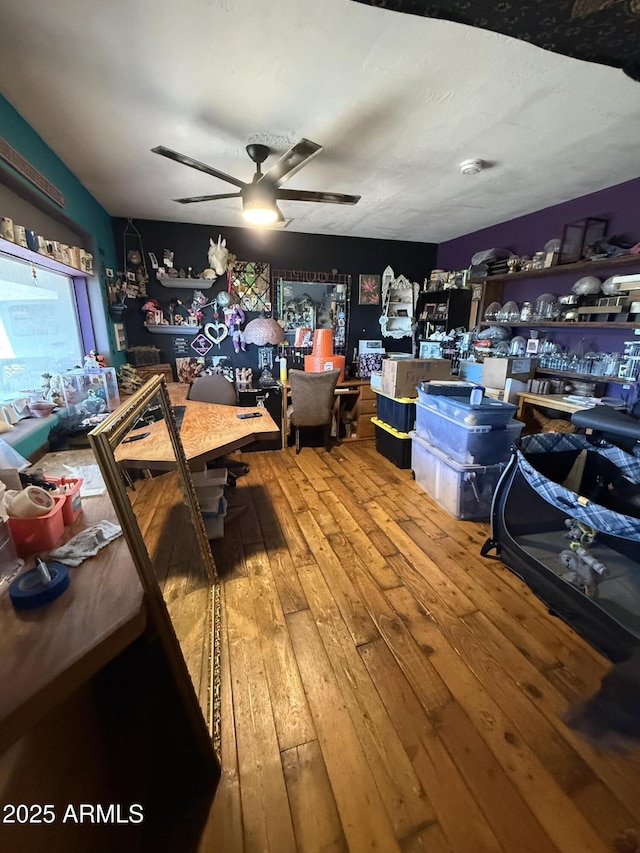 misc room with ceiling fan and wood-type flooring