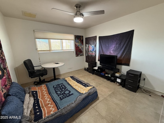 interior space with ceiling fan and light tile patterned flooring