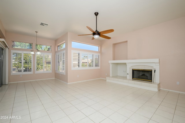 unfurnished living room with plenty of natural light, light tile patterned floors, and a fireplace