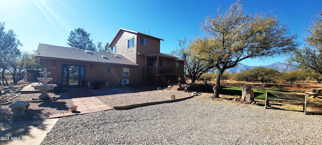 rear view of house featuring a patio area and a mountain view