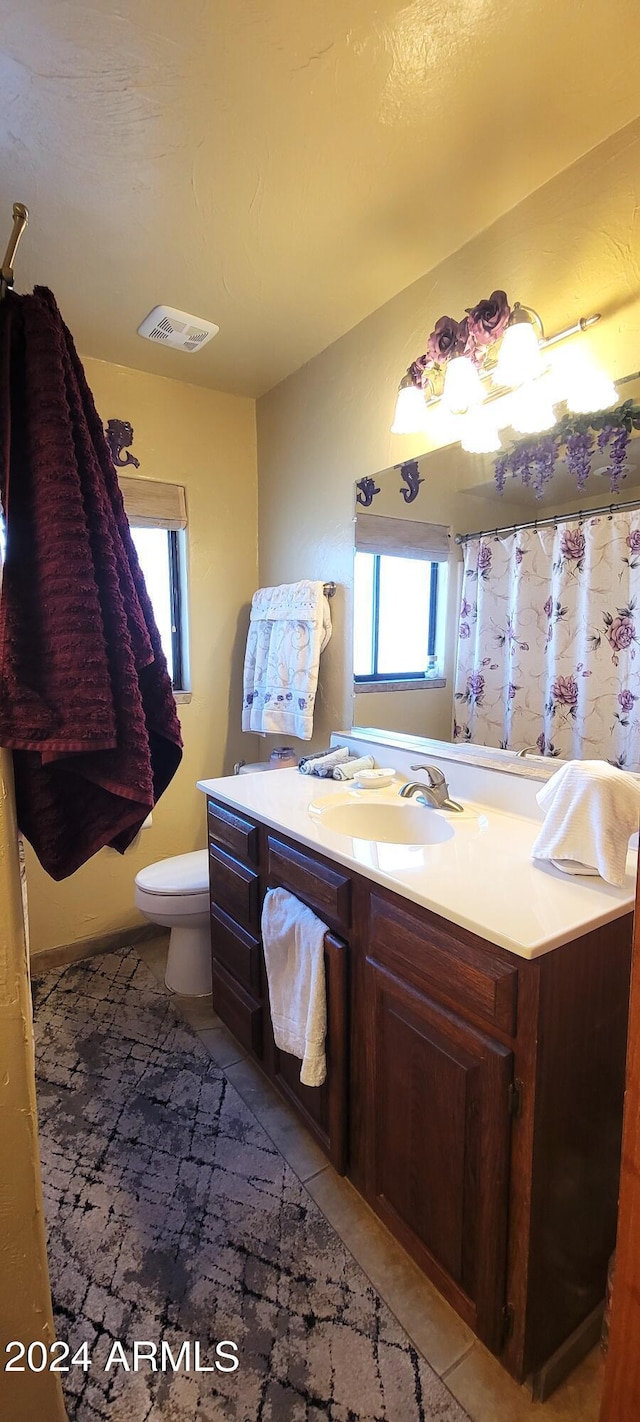 bathroom with tile patterned floors, vanity, and toilet