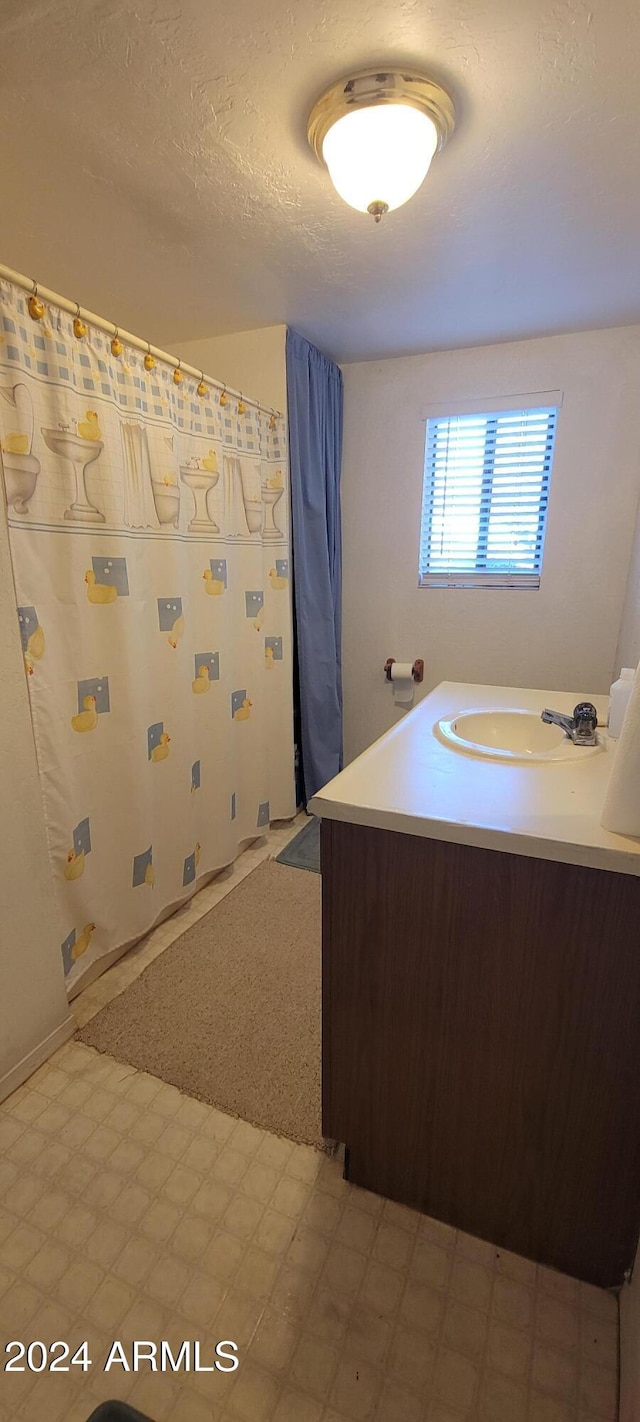 bathroom with a textured ceiling and sink