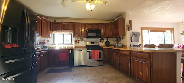 kitchen featuring kitchen peninsula, ceiling fan, sink, black appliances, and light tile patterned floors