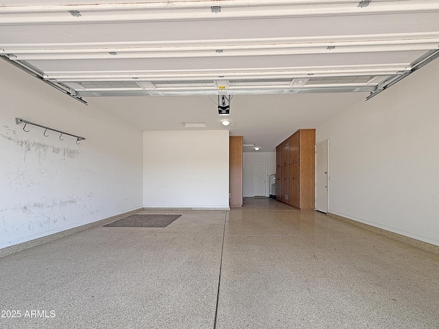 14572 W Medlock Dr, Litchfield Park, AZ 85340 - garage featuring a garage door opener and baseboards