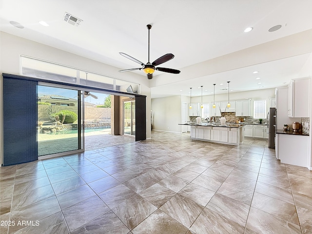 14572 W Medlock Dr, Litchfield Park, AZ 85340 - living area with recessed lighting, ceiling fan, light marble finish flooring, and baseboards