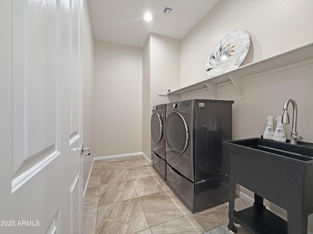 14572 W Medlock Dr, Litchfield Park, AZ 85340 - laundry area with washing machine and dryer, light marble finish flooring, and baseboards