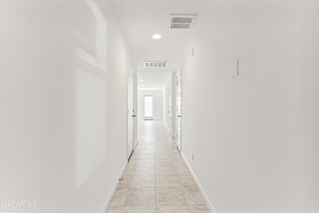 hall with light tile patterned floors