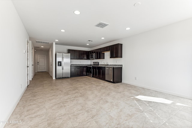 kitchen featuring appliances with stainless steel finishes and dark brown cabinets