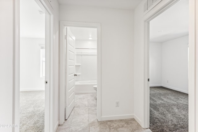 corridor with light colored carpet