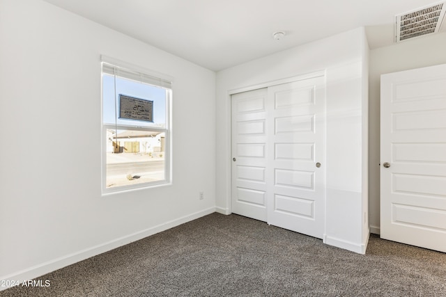 unfurnished bedroom with carpet and a closet