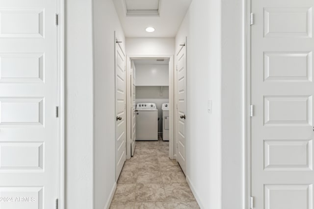 hallway with washing machine and dryer