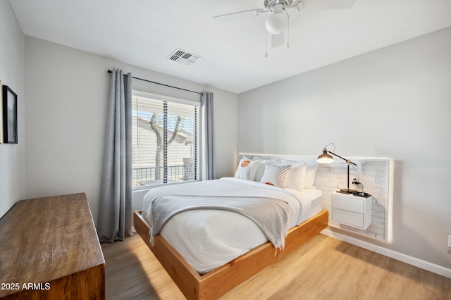 bedroom featuring hardwood / wood-style flooring and ceiling fan