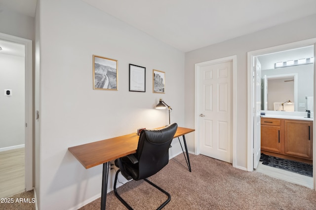 office area with sink and light carpet