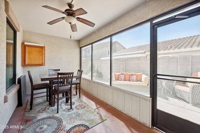 sunroom featuring ceiling fan