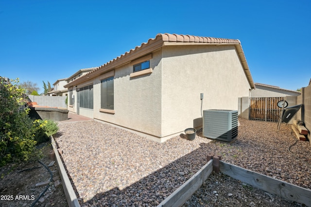 view of side of property with central AC