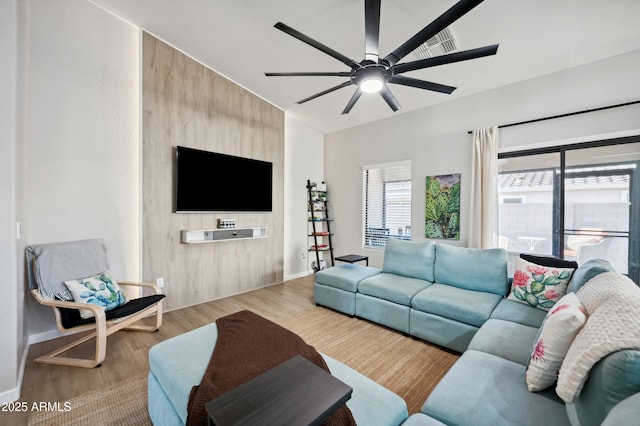 living room featuring ceiling fan and light hardwood / wood-style floors